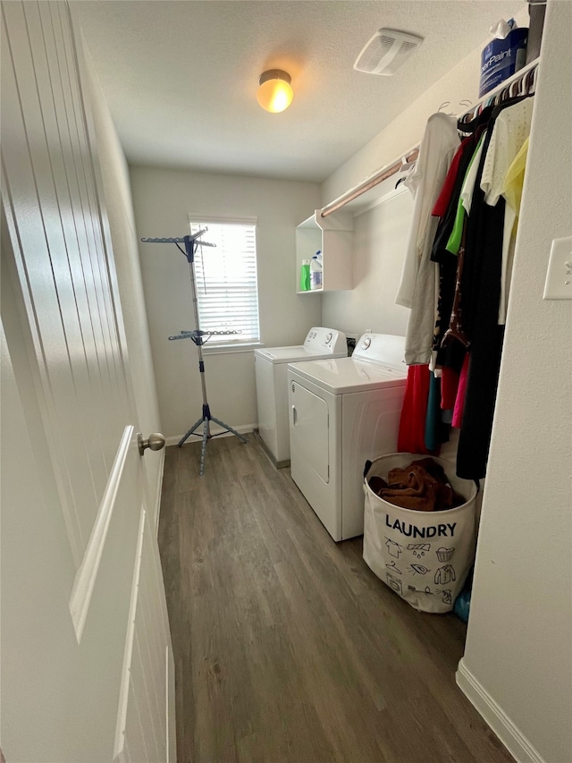 laundry area with washer and clothes dryer and dark hardwood / wood-style floors