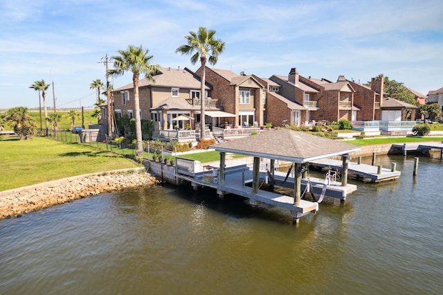 7109 Broadway St, Galveston, TX 77554 - view of dock featuring fence, boat lift, a lawn, a water view, and a residential view
