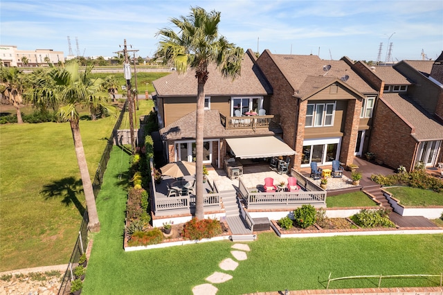 view of front of home with a patio, a deck, a front lawn, and outdoor lounge area