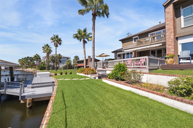 view of yard featuring a water view, a boat dock, and a balcony