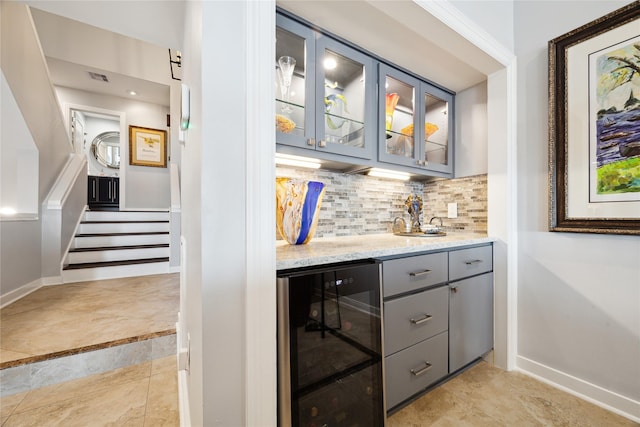 7109 Broadway St, Galveston, TX 77554 - bar with indoor wet bar, beverage cooler, baseboards, and backsplash