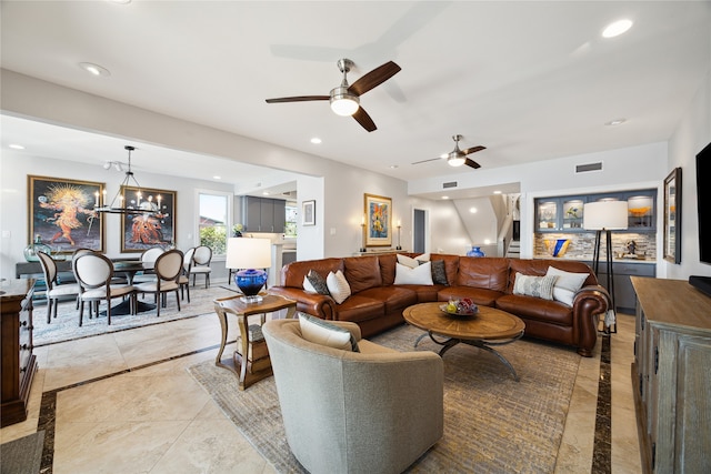 living room featuring ceiling fan with notable chandelier