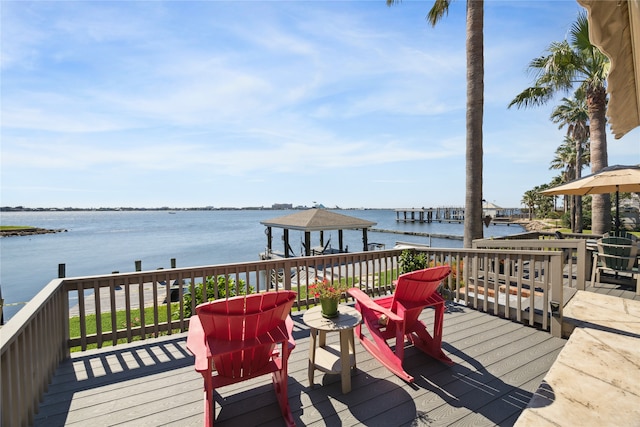 wooden terrace featuring a water view