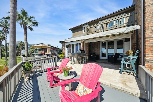 wooden terrace featuring a patio area