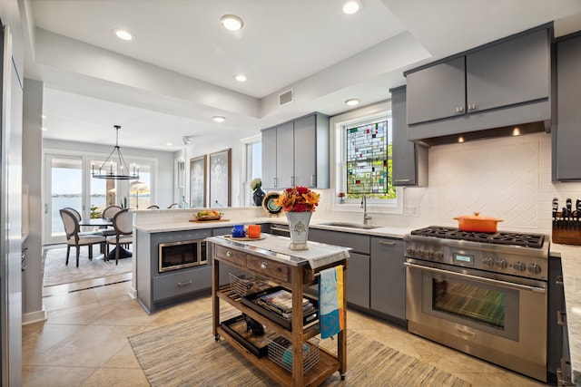 7109 Broadway St, Galveston, TX 77554 - kitchen featuring a sink, appliances with stainless steel finishes, gray cabinetry, and visible vents