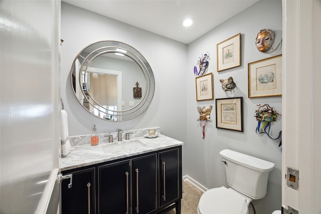 bathroom with vanity, toilet, and tile patterned floors