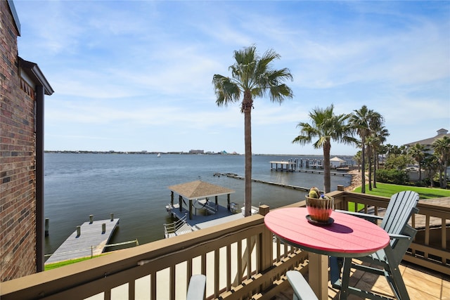 wooden deck featuring a dock and a water view