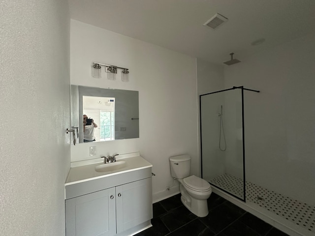 bathroom featuring toilet, a shower with shower door, vanity, and tile patterned flooring