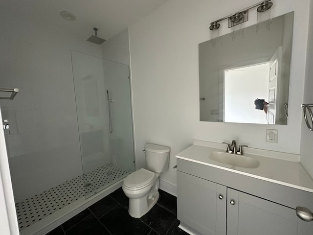 bathroom with vanity, toilet, tile patterned floors, and tiled shower