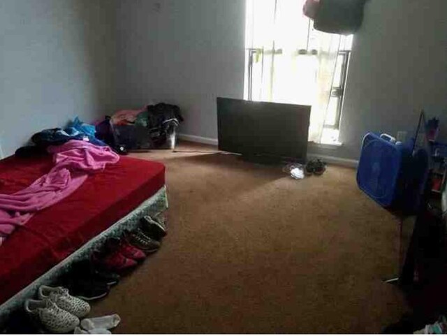 6516 Sidney St Unit A, Houston, TX 77021 - carpeted bedroom featuring baseboards