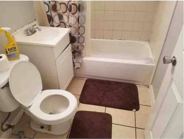 full bathroom with tile patterned flooring, toilet, shower / bath combo, and vanity