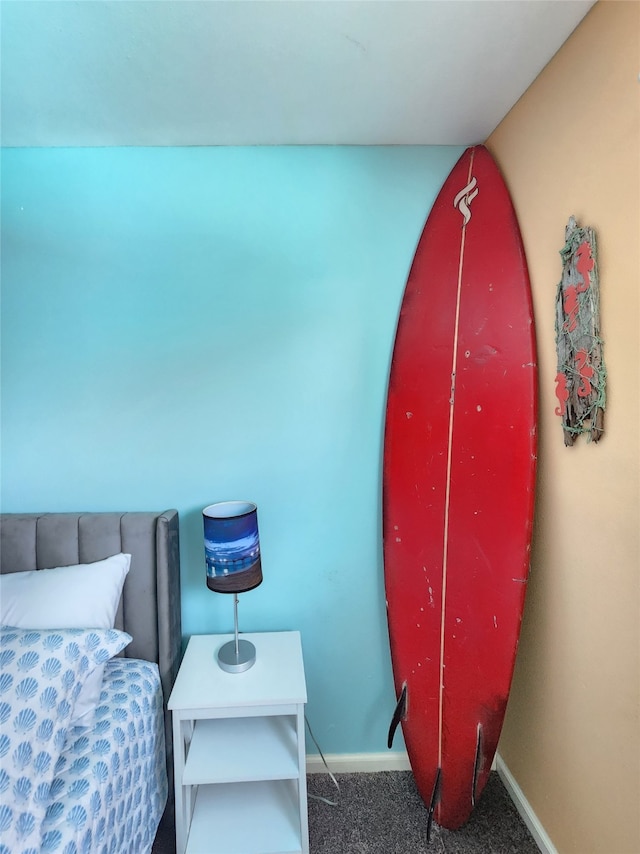 bedroom featuring dark carpet