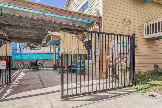 view of gate featuring a patio area