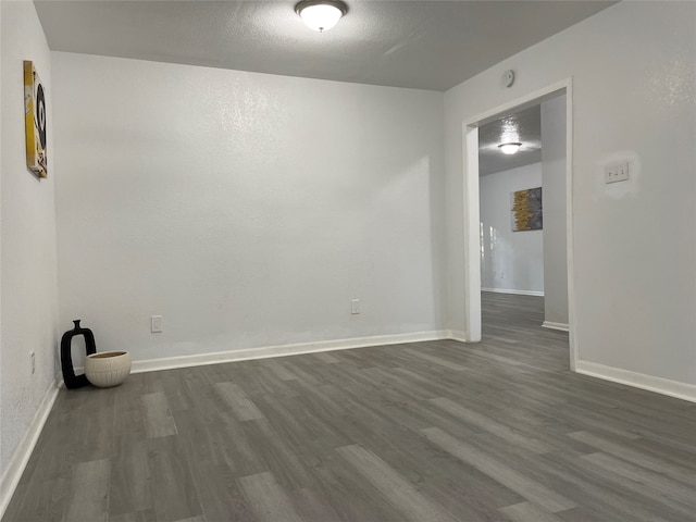 empty room featuring dark wood-type flooring