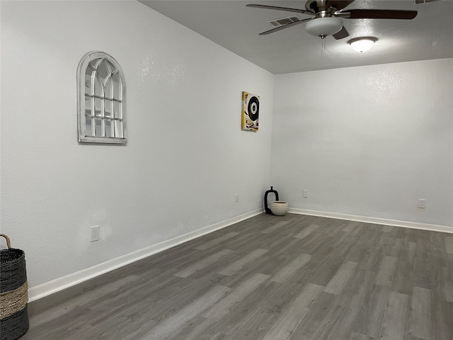 empty room with ceiling fan and wood-type flooring