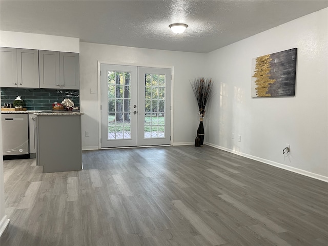 interior space featuring french doors, a textured ceiling, and wood-type flooring