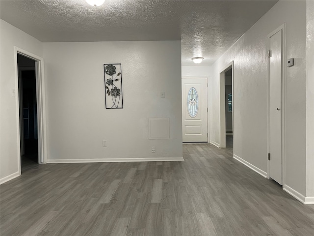 foyer featuring hardwood / wood-style flooring and a textured ceiling