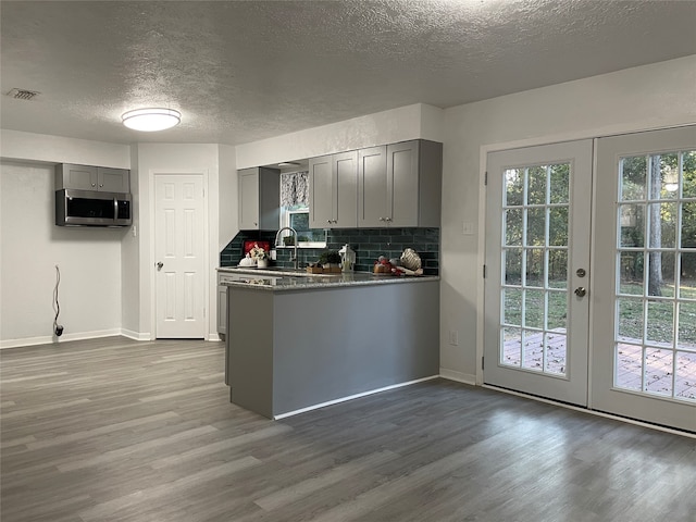 kitchen with hardwood / wood-style floors, french doors, and gray cabinetry