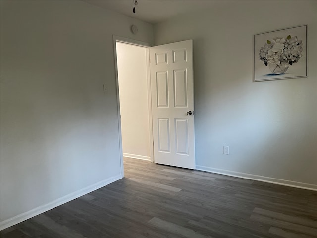 spare room featuring dark wood-type flooring