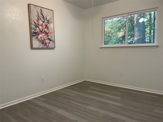 unfurnished room featuring dark hardwood / wood-style flooring