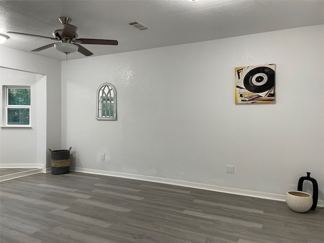 spare room with ceiling fan and hardwood / wood-style flooring