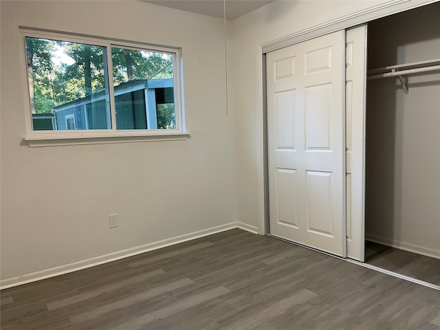 unfurnished bedroom with dark wood-type flooring