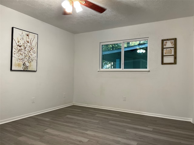 empty room with dark hardwood / wood-style flooring, a textured ceiling, and ceiling fan