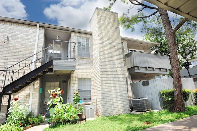 9700 Leawood Blvd Unit 2110, Houston, TX 77099 - view of side of property featuring a balcony, fence, central AC unit, and brick siding