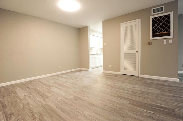 unfurnished room featuring hardwood / wood-style flooring