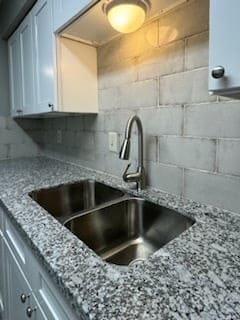 9700 Leawood Blvd Unit 2110, Houston, TX 77099 - kitchen with a sink, light stone counters, and decorative backsplash