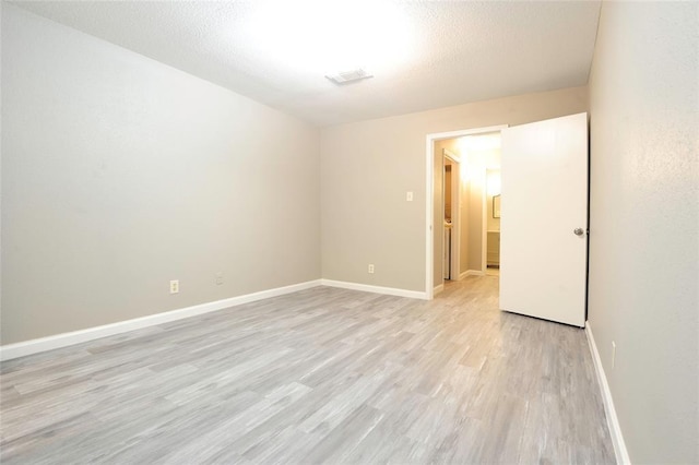 9700 Leawood Blvd Unit 2110, Houston, TX 77099 - spare room featuring light wood-type flooring and baseboards