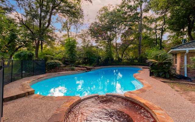 view of pool at dusk