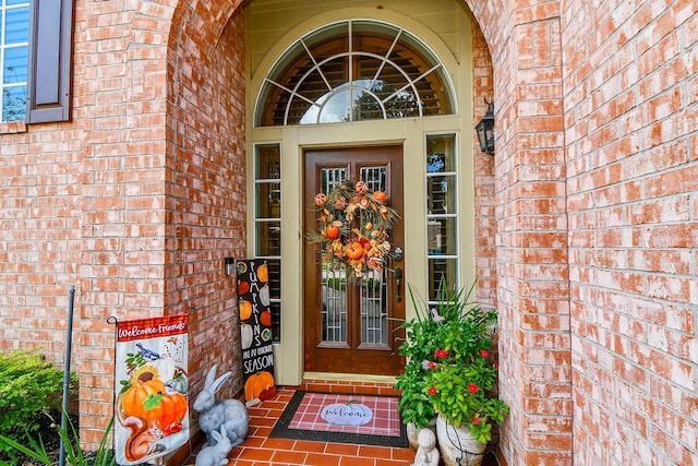 view of exterior entry with french doors and brick siding