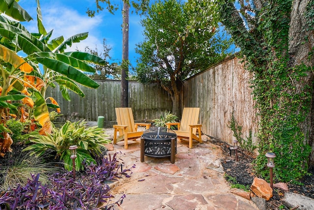 view of patio / terrace with an outdoor fire pit and a fenced backyard