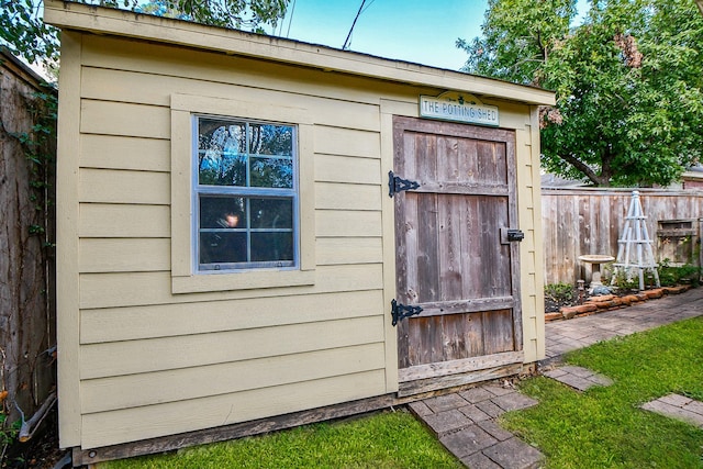 view of shed featuring fence