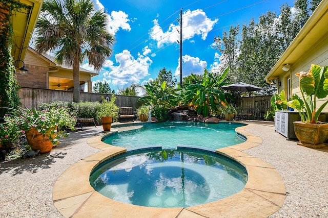 view of pool featuring a patio area, a fenced backyard, and a pool with connected hot tub