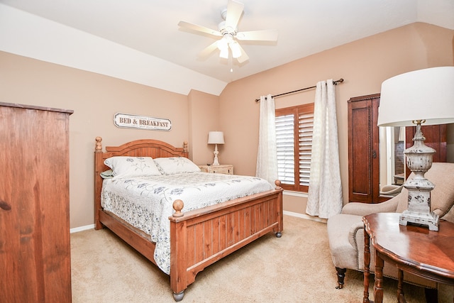 bedroom featuring a ceiling fan, lofted ceiling, light colored carpet, and baseboards