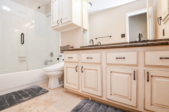 bathroom with a sink, bathing tub / shower combination, toilet, and double vanity