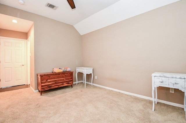 interior space featuring lofted ceiling, carpet, visible vents, and baseboards