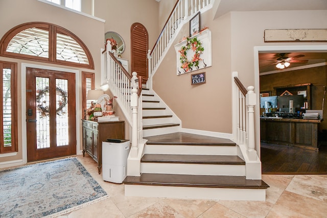 foyer with a high ceiling and stairs