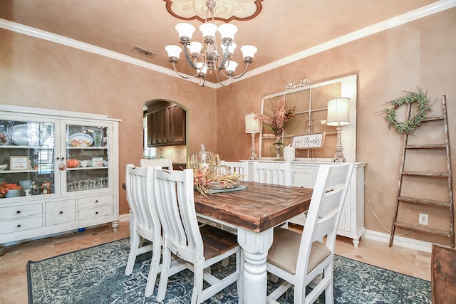 dining area with arched walkways, a chandelier, visible vents, and crown molding