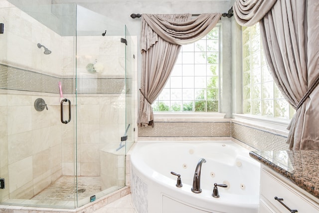 full bath with a tub with jets, a stall shower, and plenty of natural light