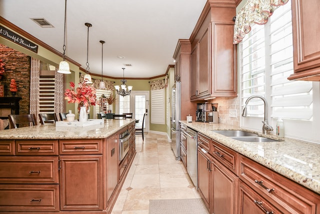 kitchen with crown molding, appliances with stainless steel finishes, decorative backsplash, and a sink