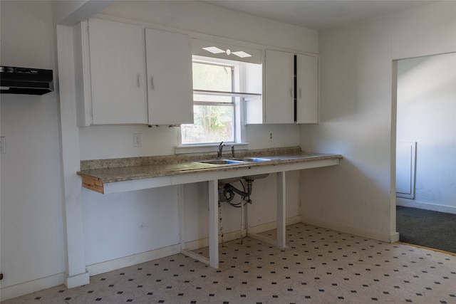 kitchen featuring white cabinets and sink