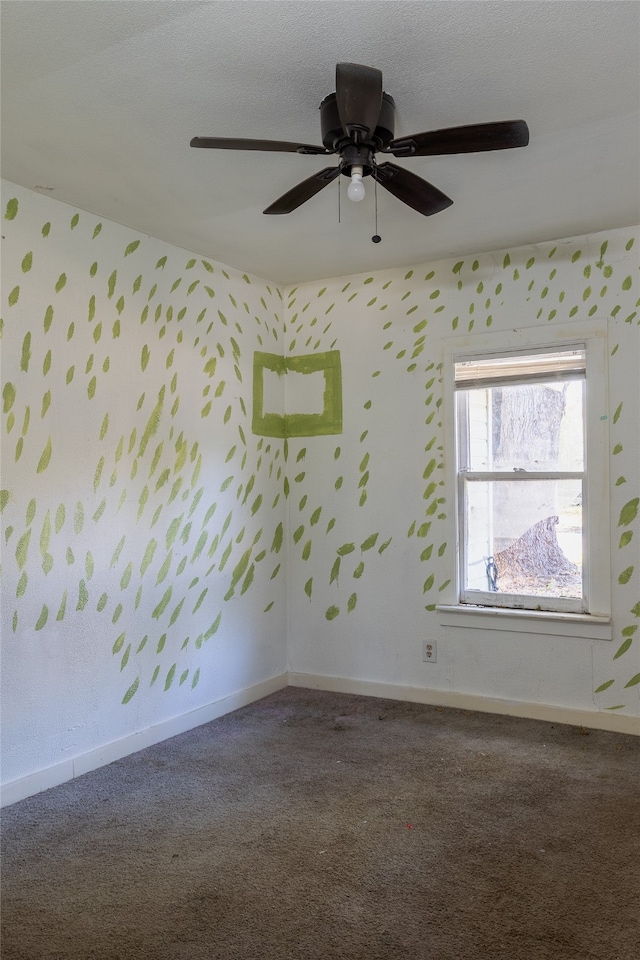 empty room with ceiling fan, a textured ceiling, and carpet floors