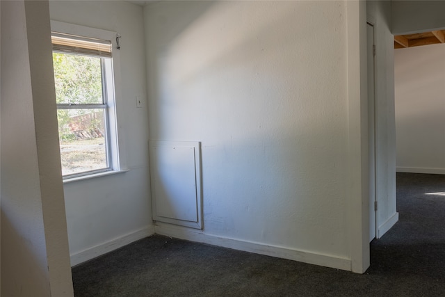 empty room featuring dark carpet