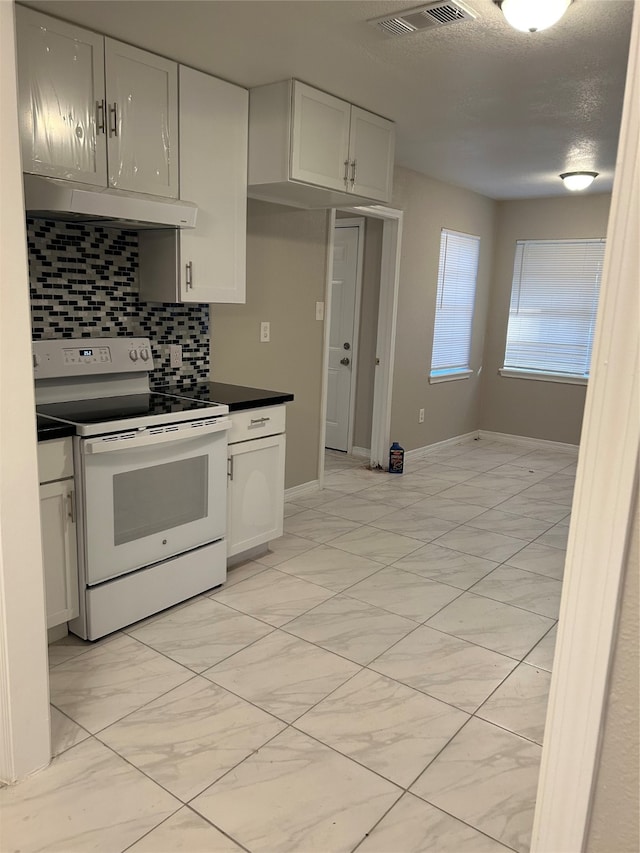 kitchen with white electric stove, a textured ceiling, decorative backsplash, and white cabinets