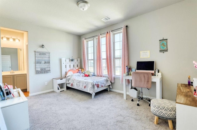 bedroom featuring light carpet and ensuite bathroom