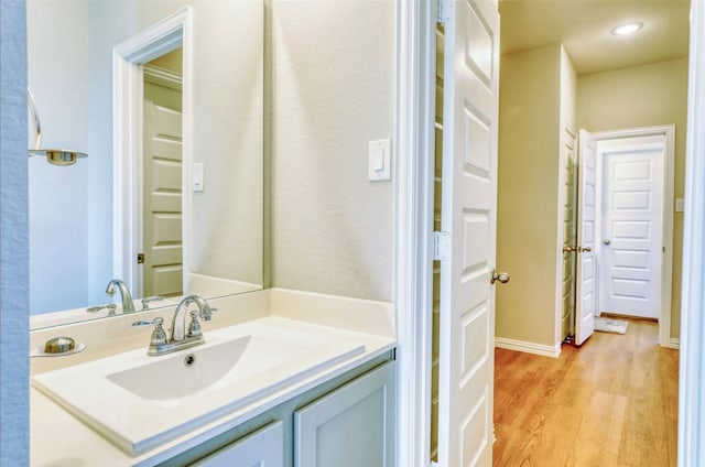 bathroom with vanity and hardwood / wood-style flooring