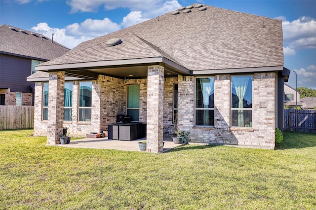 back of property featuring a patio area and a yard